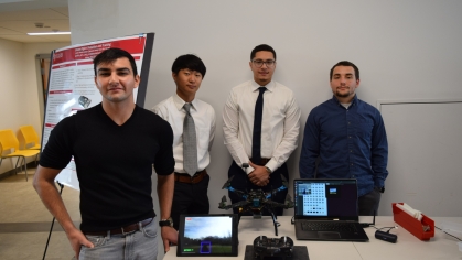 Four male students present their drone research project.