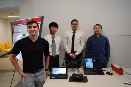 Four male students present their drone research project.
