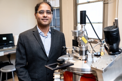 Male engineering professor in a lab wearing blazer and light-colored shirt